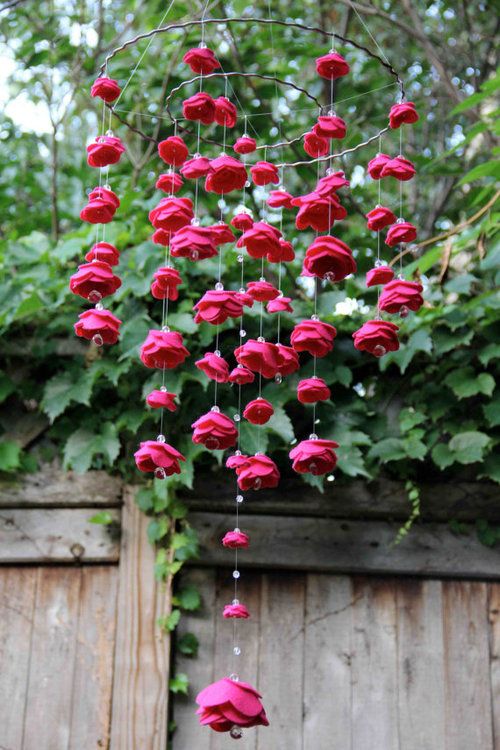 a fuchsia felt flower chandelier with crystals will be a nice decoration for a bold wedding in summer