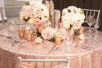 a glam rose gold sequin tablecloth, rose bows on the chairs and touches of godl and silver for a glam tablescape