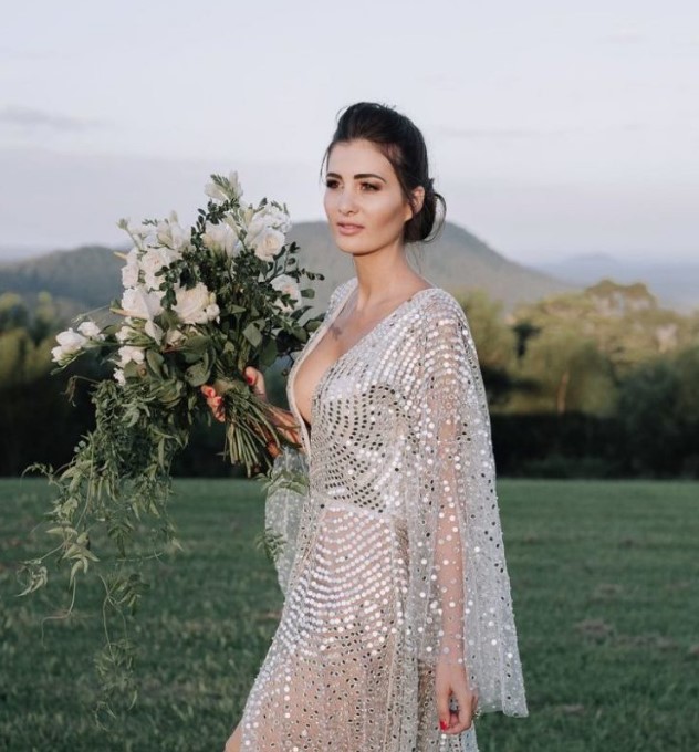 a gorgeous modern silver wedding dress with a nude underdress, wide sleeves and a plunging neckline and large sequins