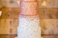 a large wedding cake with rose gold dots is a bold and chic idea for a modern glam wedding