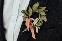 a leaf wreath boutonniere with a peachy ribbon and a colorful bow tie for accessorizing a boho look