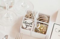 a mini box with various chocolate and a tag on top is a lovely wedding favor idea to enjoy