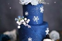 a stylish winter wedding cake with snowflakes