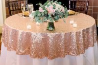 a partly rose gold sequin tablecloth paired with a lvoely pink rose centerpeice and candles is wow