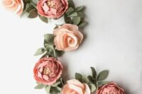 a peony and rose felt garland with leaves is a cool and simple decoration for a wedding, especially in spring or summer