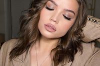 a perfect holiday makeup with a matte nude lip, silver metallic eyeshadow, perfect tone and a touch of blush