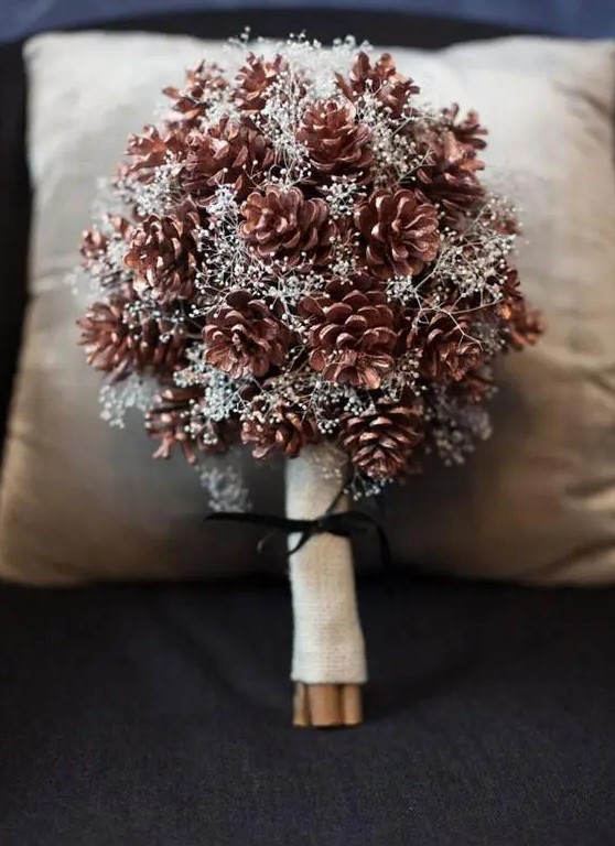 a pinecone and silver foliage wedding bouquet with a burlap wrap and a black ribbon bow is a great idea for winter