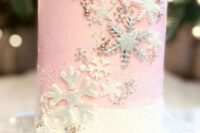 a pink and white wedding cake decorated with edible beads, white and silver snowflakes all over is a chic and lovely idea