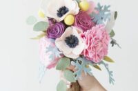 a pink felt flower wedding bouquet with billy balls, leaves and a burlap wrap is a stylish idea for spring or summer