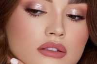 a polished holiday makeup with a matte pink lip, pink and metallic eyeshadows and a touch of pink blush