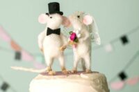 a pretty felt mouse couple dressed as a bride and a groom are lovely wedding cake toppers to try