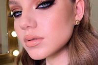 a shiny holiday makeup with a glossy nude lip, a touch of blush, smokey eyes with metallic eyeshadow