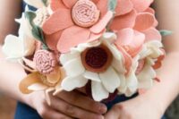 a simple and lovely wedding bouquet of white and pink felt flowers and leaves is a cool idea for a bright wedding