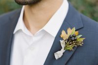 a simple leaf and dark berries boutonniere with a neutral fabric wrap for a winter touch to the look