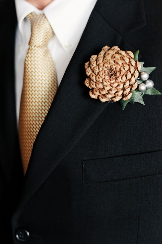 a simple winter wedding boutonniere of a pinecone, beads and a leaf will bring a slight rustic feel to the look