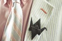 a striped suit, a pink shirt, a striped tie and a black origami boutonniere are a lovely combo for a wedding