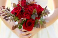 a stylish rose and dark foliage wedding bouquet for a winter or Christmas bride