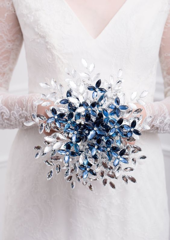 a unique rhinestone wedding bouquet of white, silver and blue pieces composing flowers and leaves is a gorgeous idea