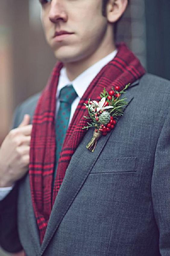 a winter wedding boutonniere of berries, greenery, a white bloom, a pinecone is a cool and bright idea