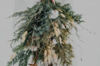 a woodland winter wedding bouquet of evergreens, berries, cotton, twigs and bunny tails is a fantastic idea