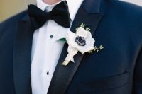 an elegant white anemone and greenery boutonniere for a fresh touch to the navy tux outfit