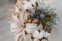 an organic winter wedding bouquet with air plants, blue thistles, and cotton is a great idea for a winter coastal bride
