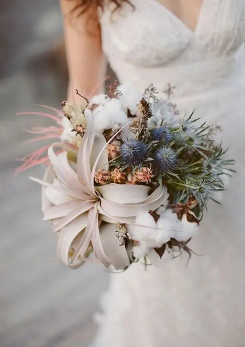 an organic winter wedding bouquet with air plants, blue thistles, and cotton is a great idea for a winter coastal bride