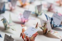 colorful origami cranes with cards are amazing for a bright and cool wedding with a touch of DIY