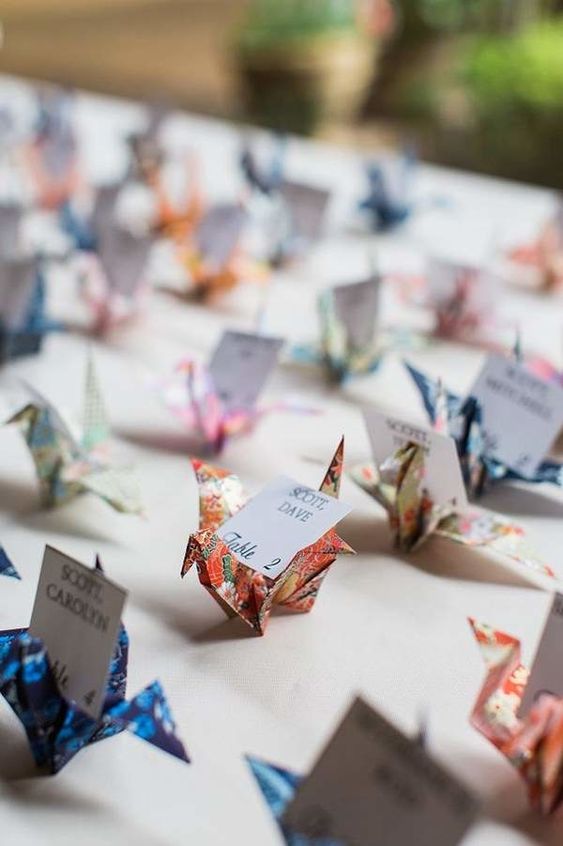 colorful origami cranes with cards are amazing for a bright and cool wedding with a touch of DIY