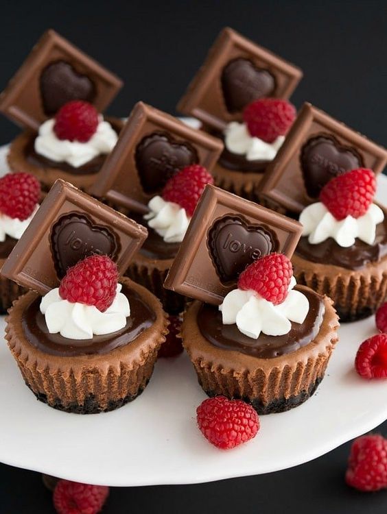 decadent chocolate mini cupcakes topped with chocolate, whipped cream and rapsberries will make you absolutely happy and amazed