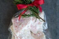 delicious peppermint bark with a red ribbon and fir twig can be given as a cool and tasty wedding favor