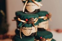 homemade jam in jars, with green suede, pinecones, berries and ribbon bows are delicious and homey wedding favors