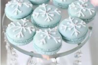 light blue macarons topped with glazed snowflakes and beads look very stylish and are perfect for a winter wedding