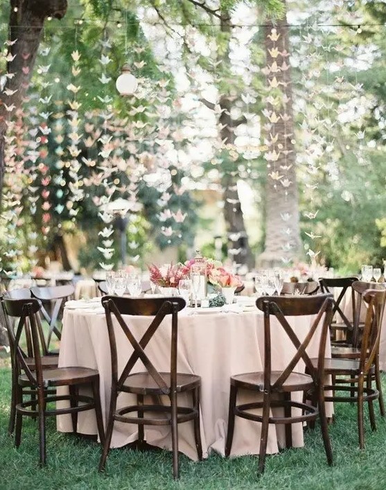 pastel origami crane garlands hanging over the whole reception for a cute look