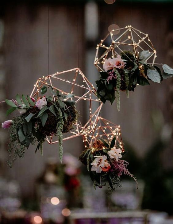 rose gold terrarium frames with lights, greenery and pink and purple blooms can be hung over your reception space