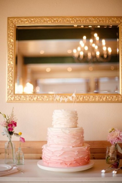 an ombre white to pink textural buttercream wedding cake with a banner cake topper is a lovely idea for a spring or summer wedding