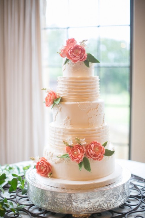 an elegant neutral patterned wedding cake decorated with coral sugar blooms and greenery is a stylish idea for a vintage wedding
