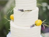 a white textural buttercream wedding cake decorated with greenery, lavender and lemons is a lovely idea for a summer wedding