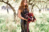 a black sequin mermaid wedding dress with a lace bodice and a bright berry-hued wedding bouquet