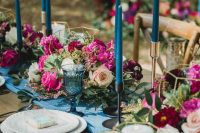a wedding tablescape with jewel-tone florals