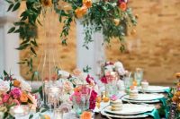 a bright and romantic wedding tablescape with hot pink, orange and white blooms, citrus and green napkins is wow