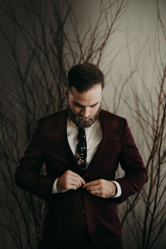 a burgundy suit, a white shirt and a dark floral tie for a moody Halloween look