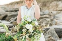 a cascading textural wedding bouquet with much greenery, herbs and some white blooms for a coastal bride