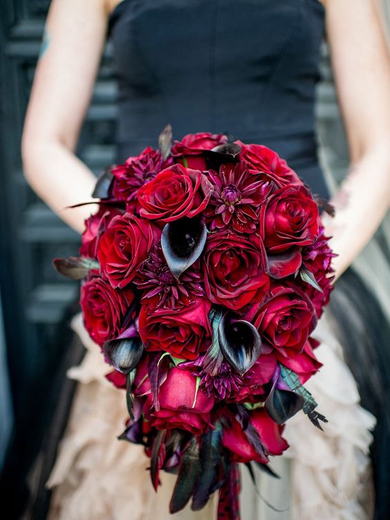 a cascading wedding bouquet of black callas and deepr red roses is ideal for a Halloween bride