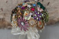 a colorful vintage brooch wedding bouquet with a tulle wrap with a bow is a chic and nice idea for a bright wedding
