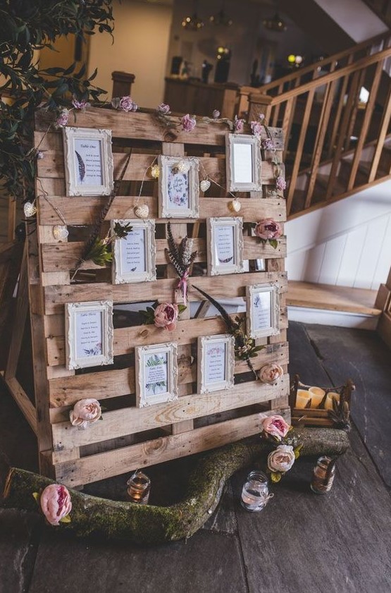 a cute wedding pallet sign with fresh blooms, foliage and favorite quotes in vintage frames plus lights