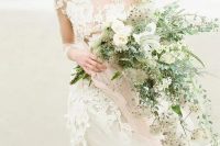 a delicate cascading wedding bouquet with light-colored greenery, neutral blooms and herbs is a lovely idea to rock