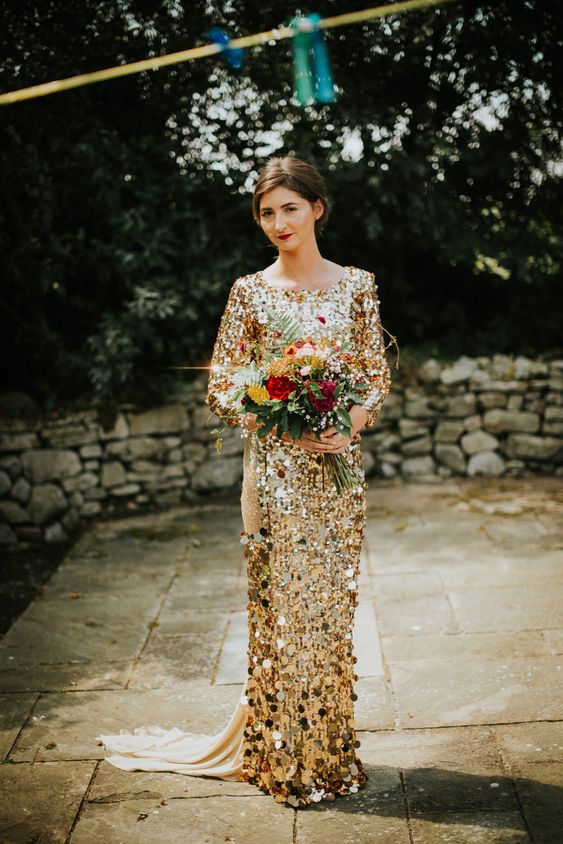 a gold chunky sequin wedding dress with a high neckline and long sleeves plus a train for a glam bridal look