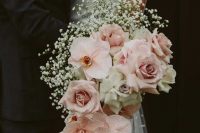 a gorgeous cascading wedding bouquet with blush roses and orchids, white roses and baby’s breath is a beautiful idea to rock