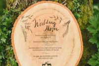 a gorgeous wood burnt tree slice wedding menu is a fantastic solution for a rustic or woodland wedding